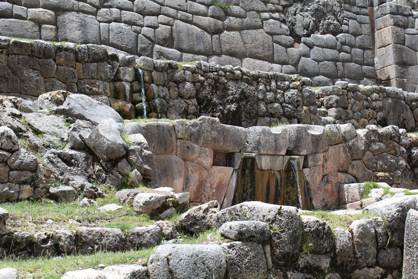 Water fountains amidst megalithic walls